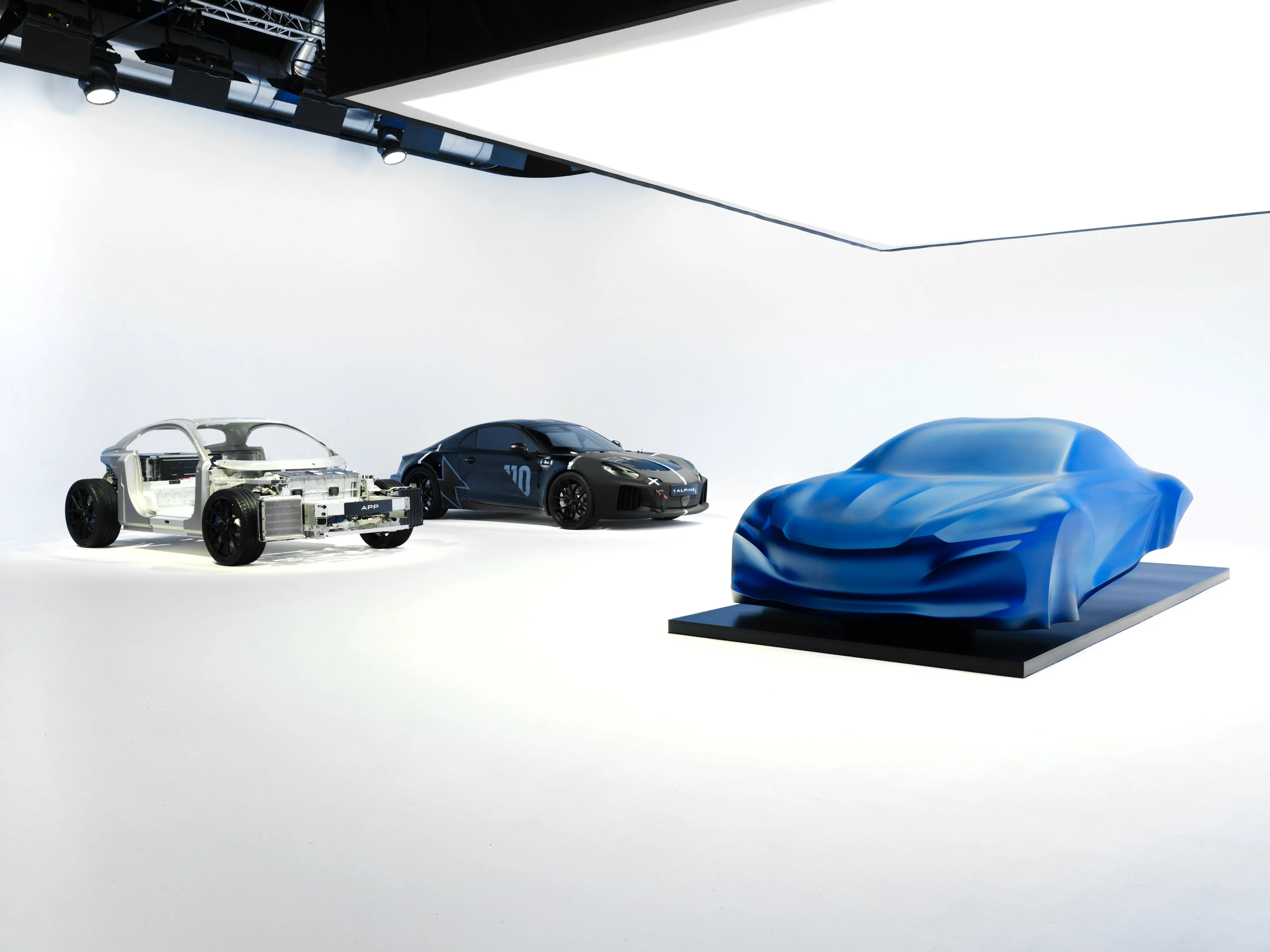 The third generation Alpine A110 pictured in parts, as a sculpture, a frame and as a disguised concept car.