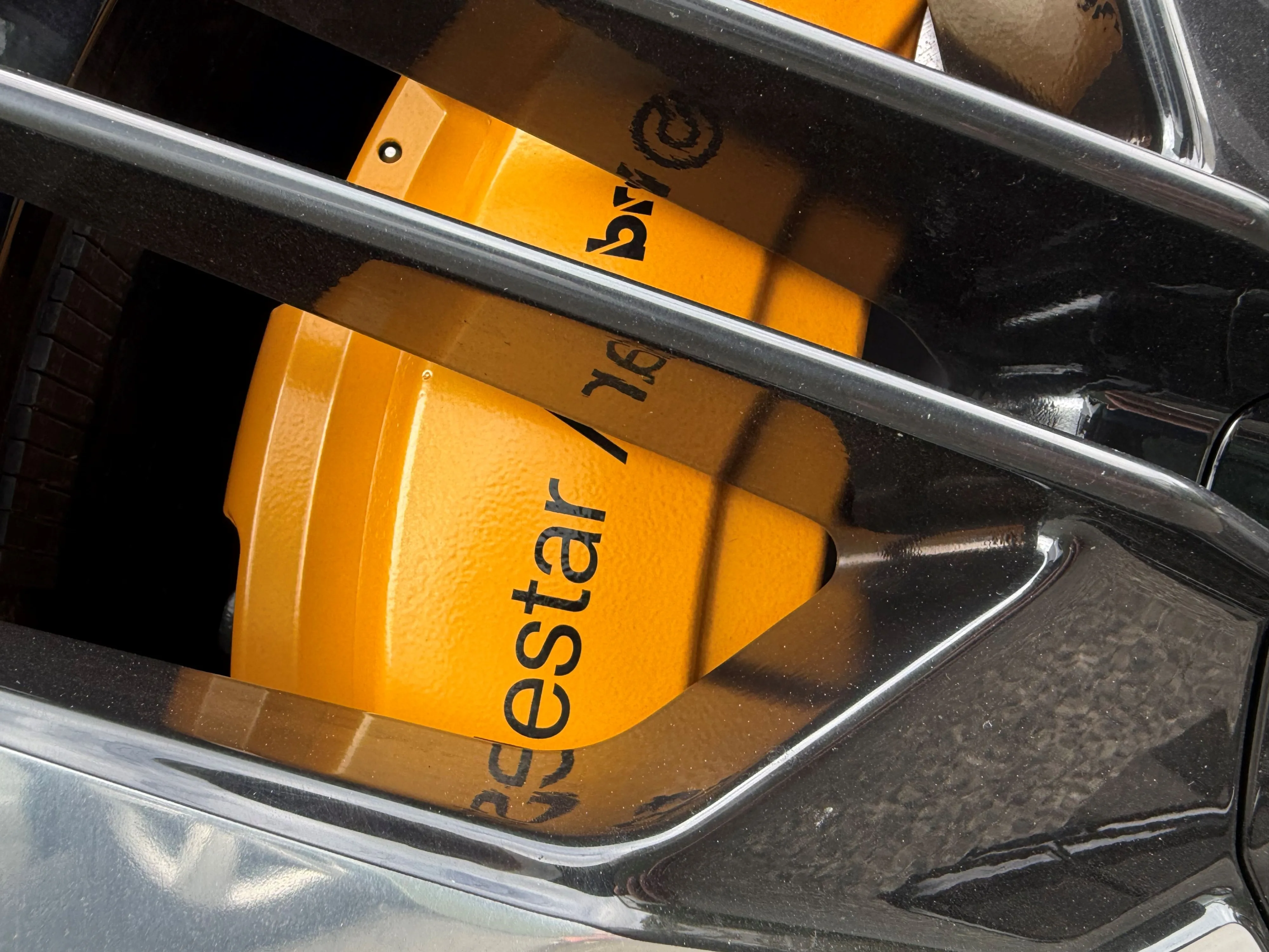 Close up of a 'Swedish Gold' painted Brembo brake caliper on the front wheel of a 2026 Polestar 3 Performance.