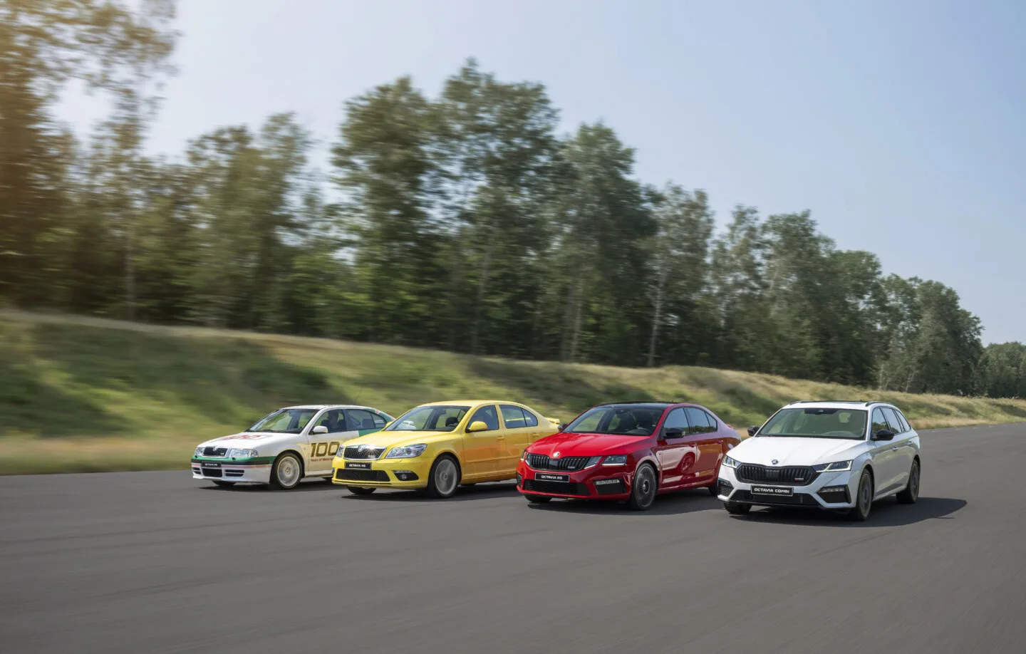 A photo of four generations of Skoda Octavia RS cars in chronological order from left to right.