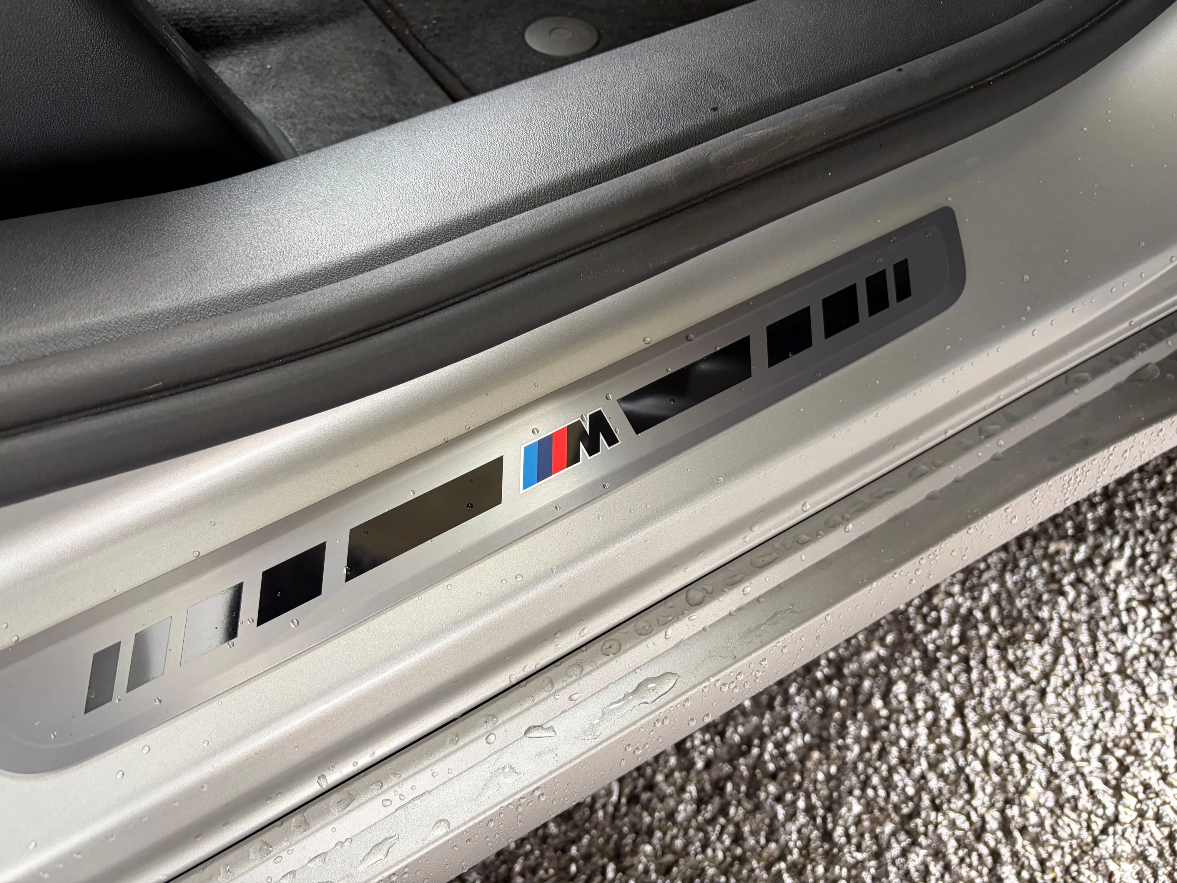 Close up of the door sills on the inside of a 2026 BMW iX3 50 in Frozen Space Silver metallic.