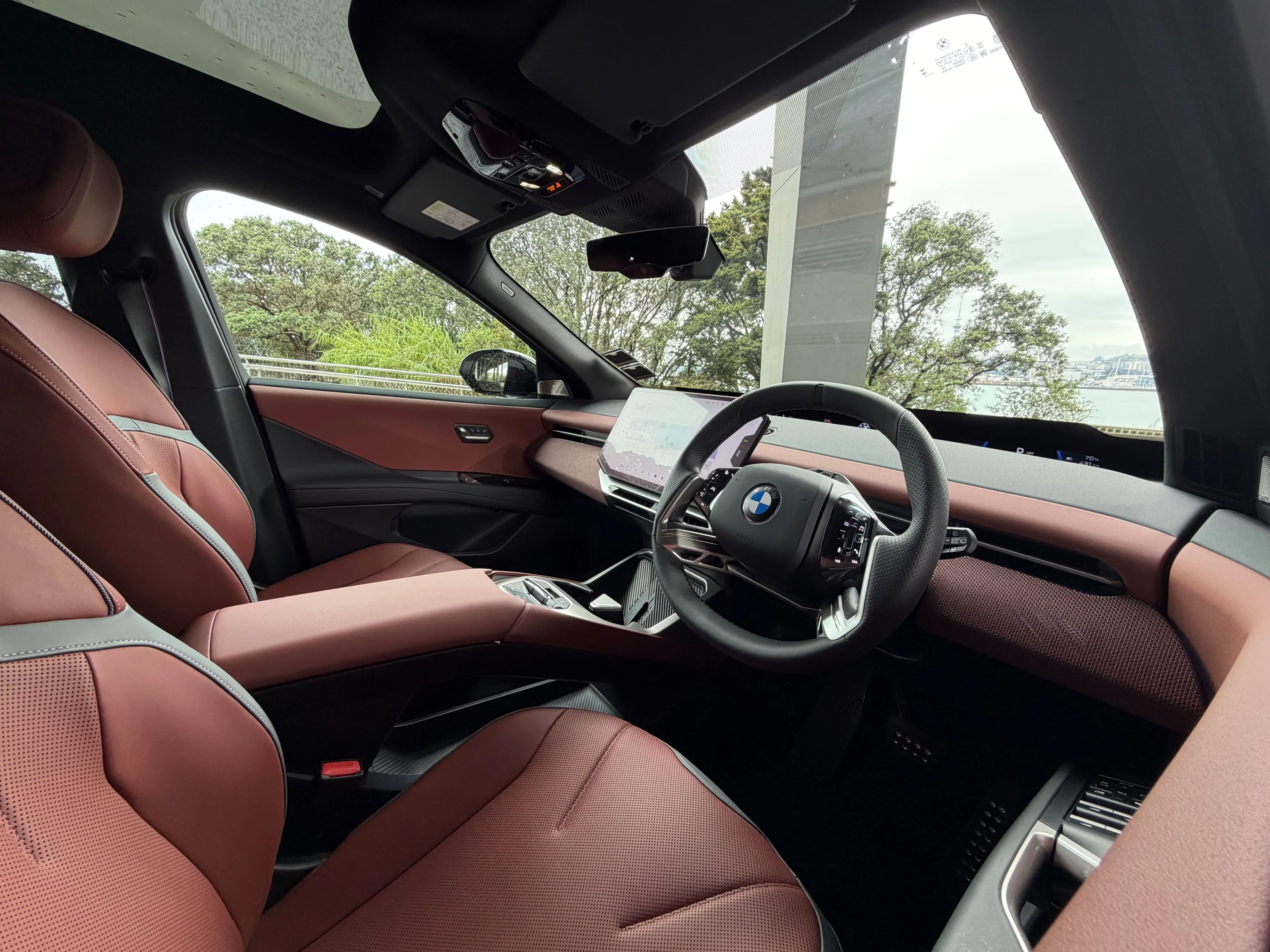 Interior view of a 2026 BMW iX3 50 in , picture taken under Auckland's Harbour Bridge.