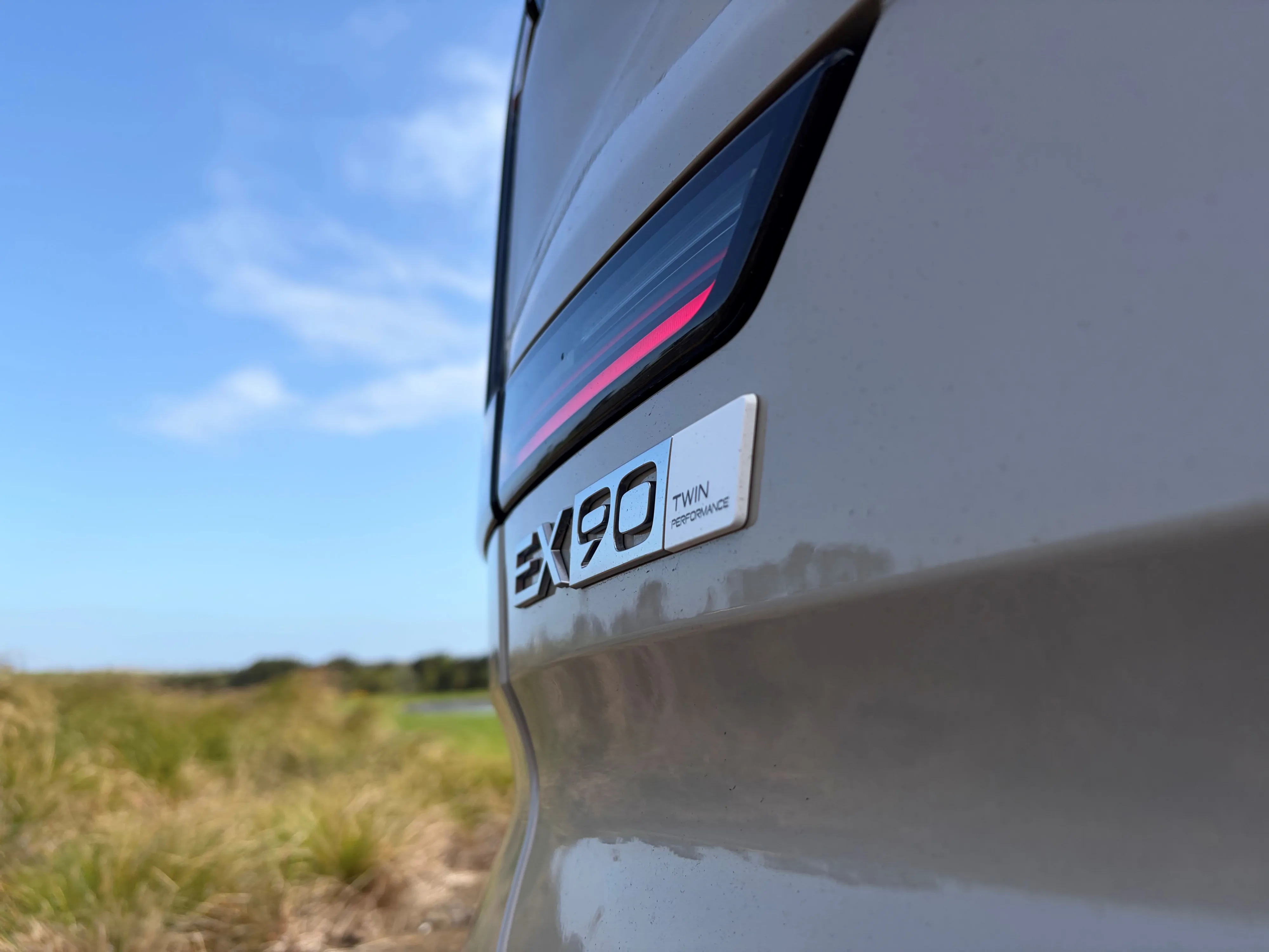 Close up of the EX90 Twin Motor badge on the rear of a 2026 Volvo EX90 Ultra Twin Motor Performance in Sand Dune.